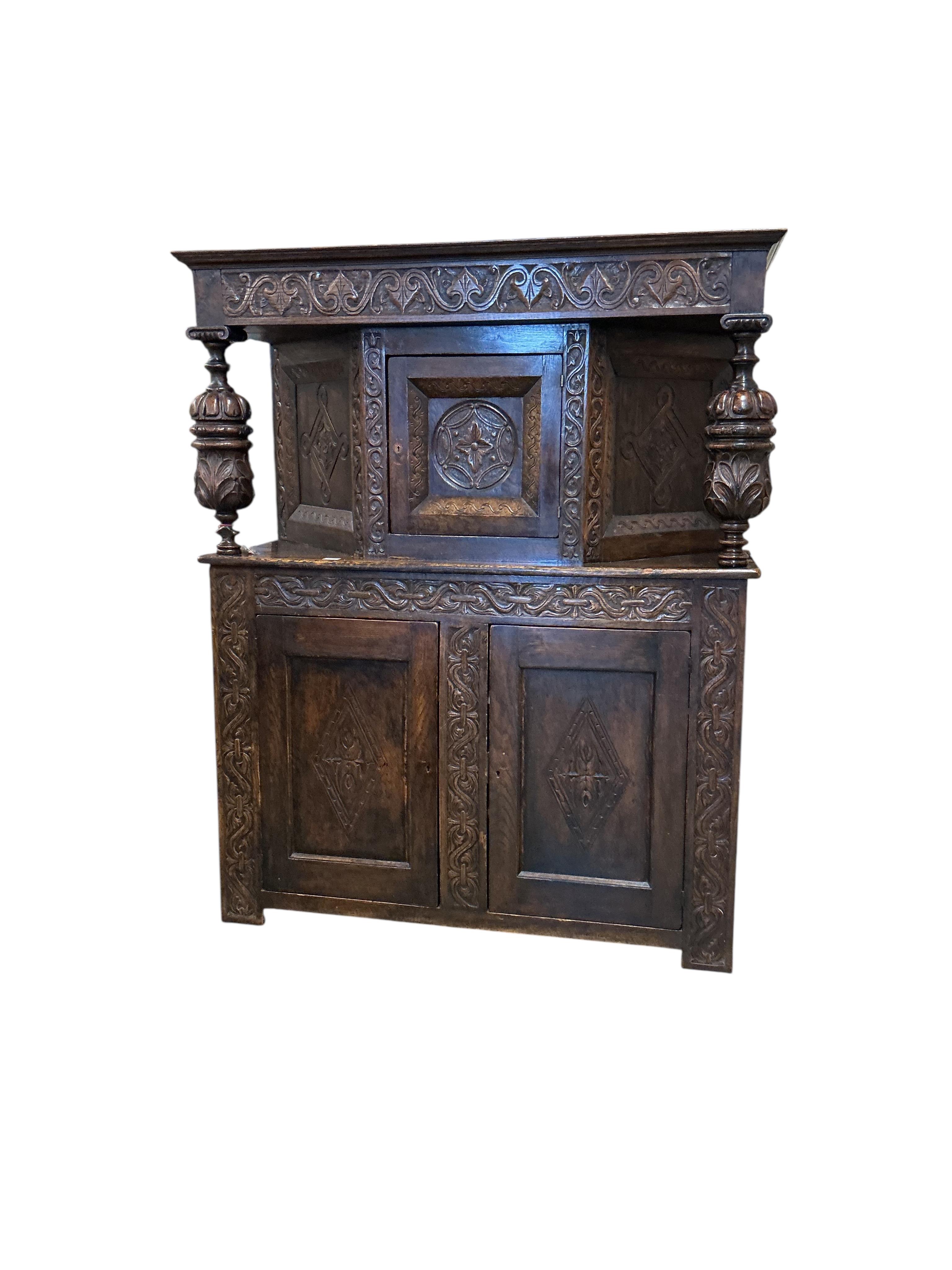A 17th century style carved oak court cupboard, width 142cm, depth 53cm, height 176cm